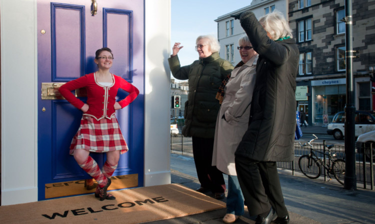 Katrina Kennedy from the Jean Swanston School of Dance performs, watched by passersby Maggie McLure, Pat Herd and Kate Fanning, at the launch of the Homecoming campaign at the Filmhouse in Edinburgh.