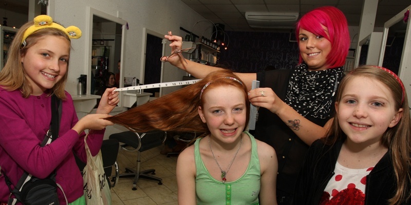 John Stevenson, Courier, 12/11/11. Dundee.The Hair Lounge, Pic shows 12 year old Dundee High School pupil Hannah Levin as she prepares to have thirteen and a half inches of her long red hair chopped off raising over £1000 for Children in Need.Hannah has also donated her hair to the Little Princess Trust.Pic shows l/r best friend Eilidh Grant, Hannah, stylist Shannon Anderson from the hair Lounge and little sister Sophie Levin.