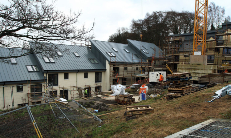 Work is progressing on the townhouses at Newmonthill after months of delay.