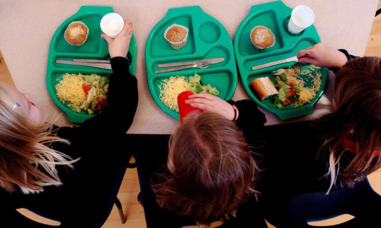 PARENTAL PERMISSION OBTAINED. Generic picture of pupils enjoying school dinners at a Primary School in Cambridgeshire.