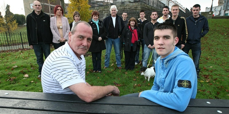 DOUGIE NICOLSON, COURIER, 19/11/11, NEWS.

Pictured at the Haugh Park in Cupar today, Saturday 19th November 2011, is Graham Lackie, left Darren's father, and Calvin Lackie, Darren's brother, with friends at the bench dedicated to soldier Darren Lackie. Story by Fife.