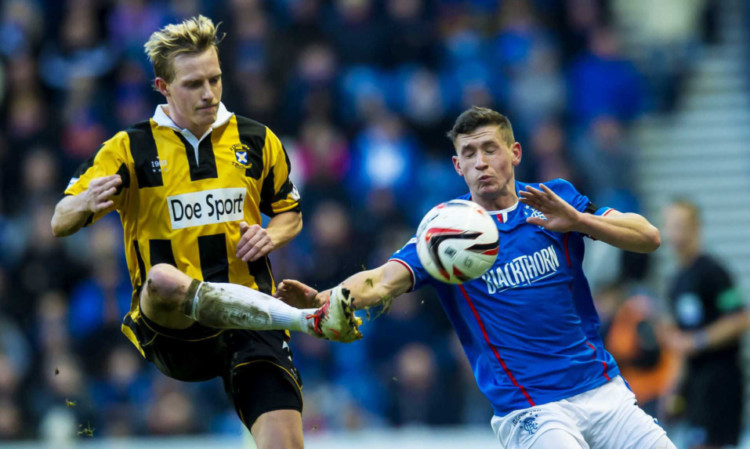 East Fifes Stevie Campbell, left, clears under pressure from Rangers Fraser Aird.