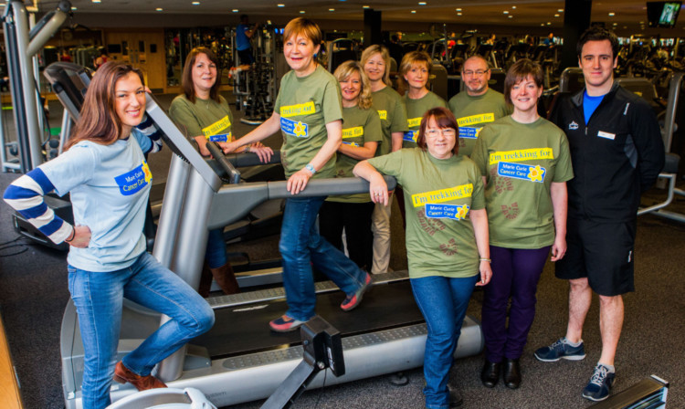 Petra McMillan, far left, with fundraisers including Susan Cleghorn on the treadmill and personal trainer Paul Carberry, far right, who will work with the group to raise their fitness levels.