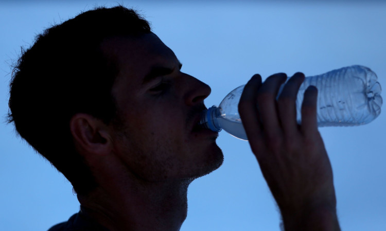 Andy Murray seeking relief from the heat during his first-round match.