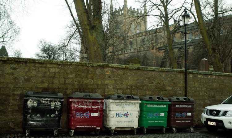 Commercial waste bins in St Catherines Wynd opposite the Old Inn on the way into the abbey grounds.