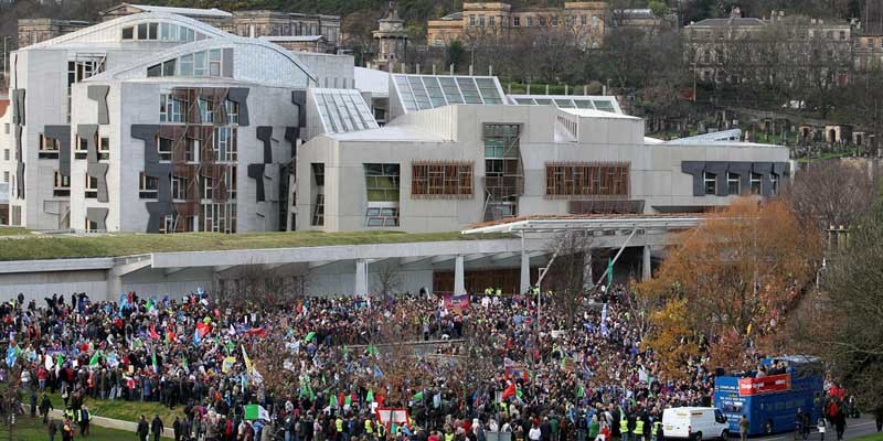 Protesters march down the Royal Mile from Edinburgh Castle to the Scottish Parliament in protest at pension cuts.