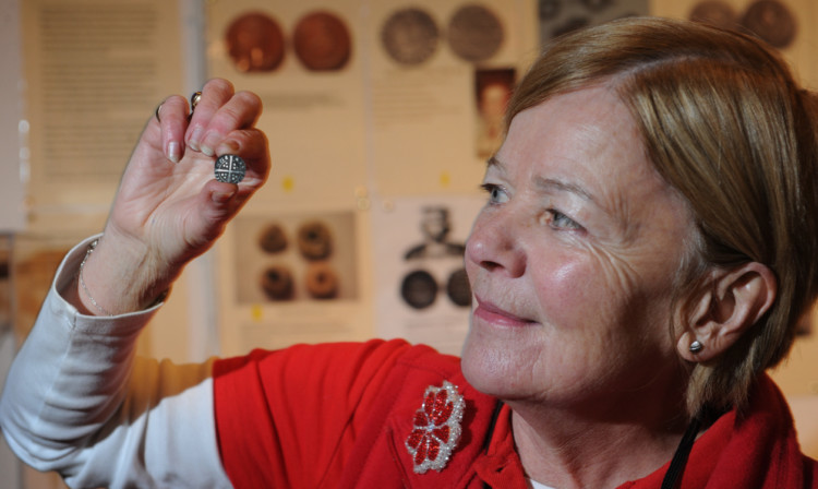 Above: Tolbooth Museum volunteeer Gwynne Stewart with the King Edward I silver penny found by Keith Knight.