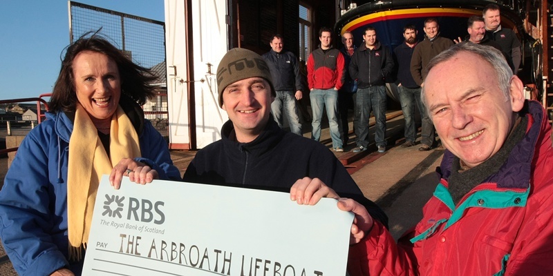 Kim Cessford, Courier - 03.12.11- pictured at the RNLI Station, Arbroath where the fee for organising and producing the 'Follow The Light' show was doanted by the organisers to the RNLI - front l to r - Edwina Barraclough, Kevin Cargill (RNLI) and James Hutcheson with back members of the Arbroath RNLI