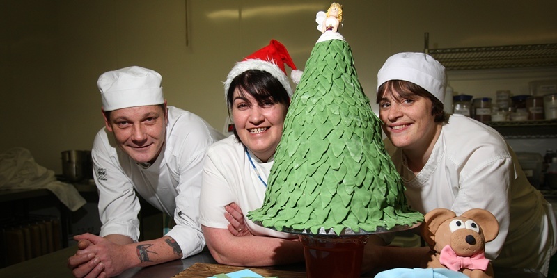 Kris Miller,Courier, 05/12/11. Picture today at Dundee College, Kingsway Campus shows the staff and students who created an 80lb Christmas cake. Pic shows L/R, Alan Waterston, Doreen Culley (Chef Lecturer) and Claire McCulloch with the cake that will be raffled off to raise funds for Cash for Kids.