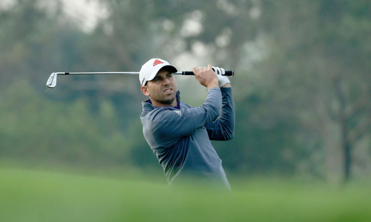 Sergio Garcia plays his second shot at the 13th hole during a round troubled by the rough.