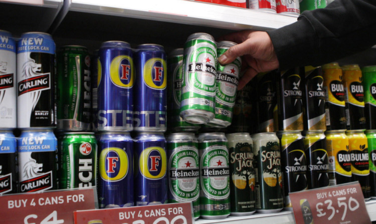 File photo dated 02/09/2010 of cans of lager and cider on the shelves in an off-licence. The Government will not go ahead with proposals for a minimum unit price for alcohol, Home Office Minister Jeremy Browne told MPs. PRESS ASSOCIATION Photo. Issue date: Wednesday July 17, 2013. See PA story HEALTH Alcohol. Photo credit should read: David Cheskin/PA Wire