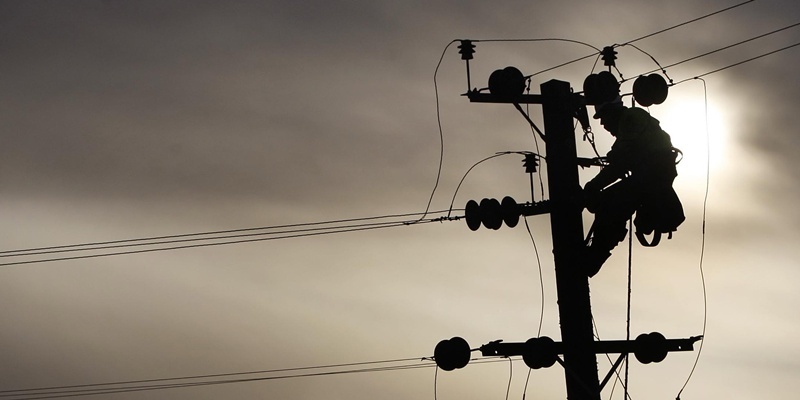 Brian Callow, linesman for HV Contracting, who are subcontractors for Scottish Power, repairs an overhead line to restore electricity to Shieldhill, Scotland, after hurricane-force winds cut off power to tens of thousands of homes.