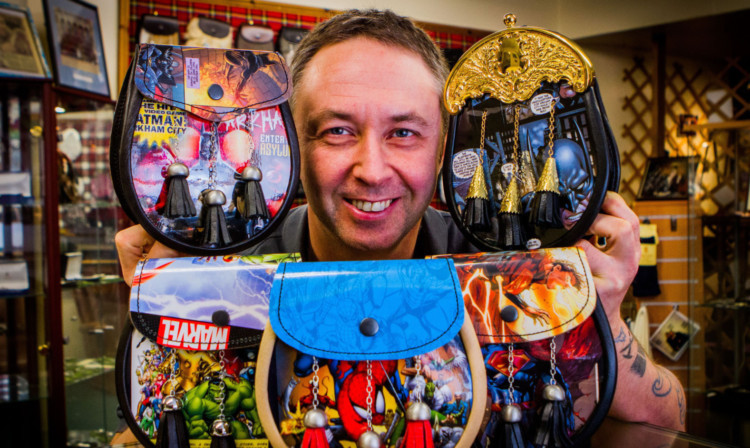 Marcus Eagleton with some of his comic designs.