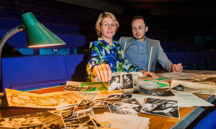 Alison McDicken and Graham King look at archive material.