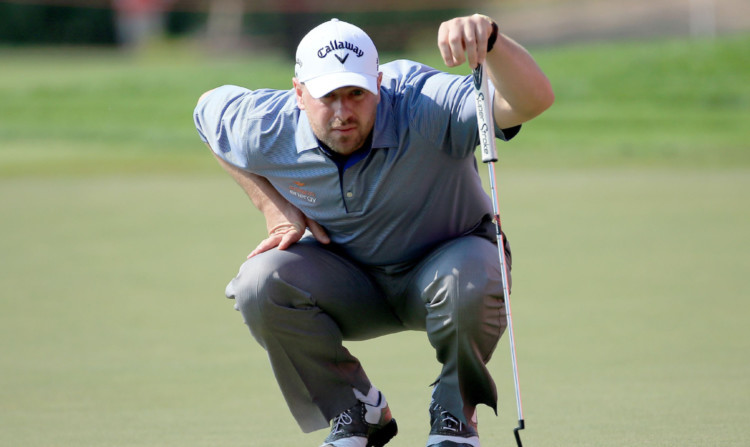 Joint leader Craig Lee lines up a birdie putt at the 17th hole.