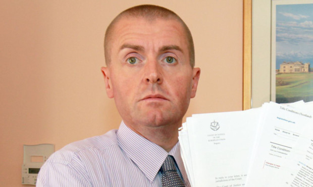 Gregor Ross with some of the paperwork involved in his court case.