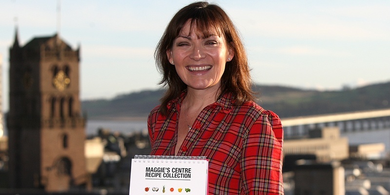 Kris Miller, Courier, 10/12/11. Picture today at Westport Appartments, Dundee where Lorraine Kelly was launching the  Maggies Centre Cookbook with various recipes including one for Lorraine Kelly's Mum's Chicken Soup. Pic shows Lorraine with the recipe book and view over Dundee in background.