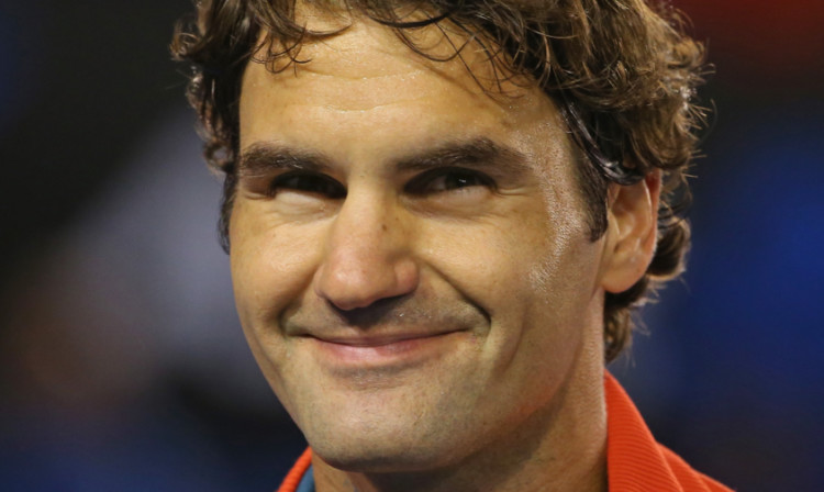 Roger Federer smiles as he celebrates victory in his fourth round match against Jo-Wilfried Tsonga.