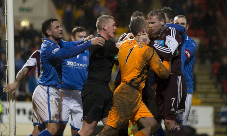 Referee Brian Colvin is forced to step in as St Johnstone keeper Alan Mannus and Hearts' Ryan Stevenson square up.