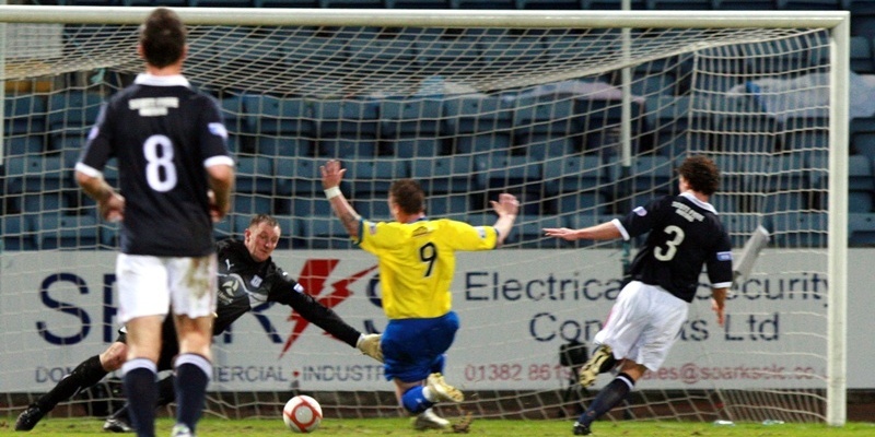 Kris Miller, Courier, 26/12/11. Dundee V Greenock Morton, 1st half. Pic shows Rab Douglas doing all he can to stop Morton's Andrew Jackson scoring (but failing).