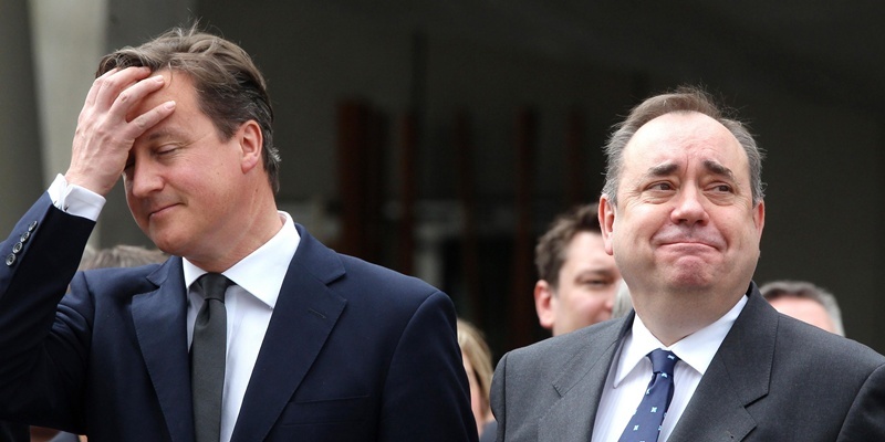 Prime Minister David Cameron (left) and First Minister Alex Salmond (right) during the march past of 2,000 serving personnel, veterans and cadets as they march down the Royal Mile from the Castle Esplanade to Holyrood Park, Edinburgh, on Armed Forces Day.