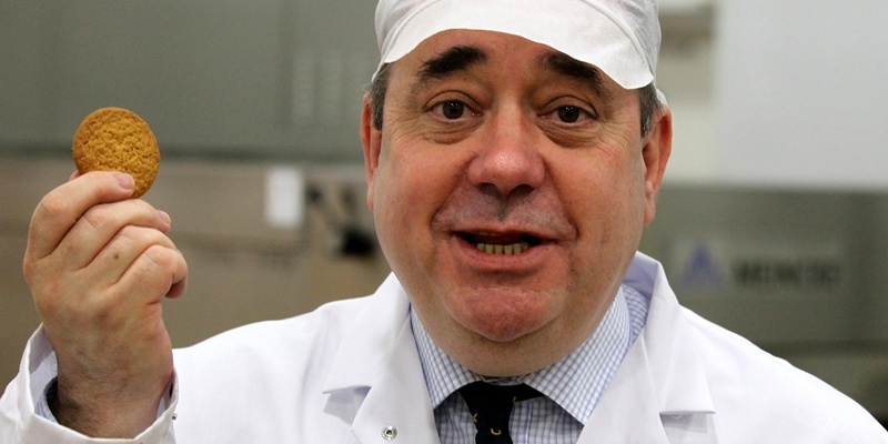 SNP leader Alex Salmond holds up a biscuit during a visit to Borders Biscuits in Lanark, whilst on the Scottish election campaign trail.