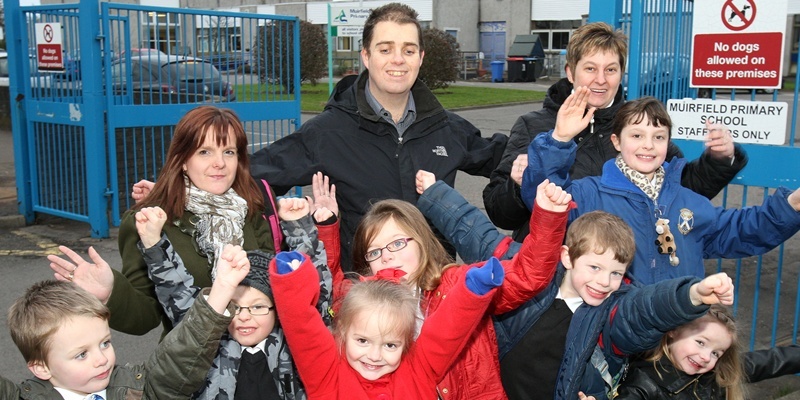 Kris Miller, Courier, 01/02/12. Picture today outside Muirfield Primary School, Arbroath shows back L/R, Amanda Thain, Ewan Smith, Karen Smith and Hannah Mullet with front L/R, Jackson SMith, Alistair Mullett, Hannah Thain, Amelie Smith, Cameron Mullet and Emma Thain celebrating success for story about school being saved from closure.
