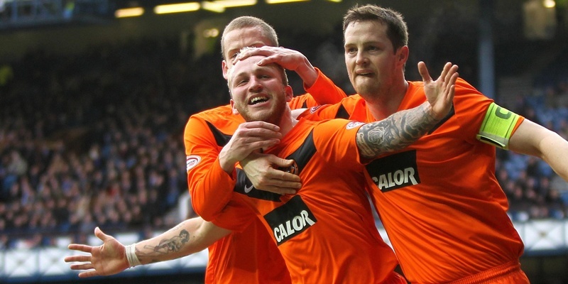 Dundee United's Johnny Russell (left) celebrates scoring his sides second goal with Jon Daly (right) during the Scottish Cup Fifth Round match at Ibrox Stadium, Glasgow.