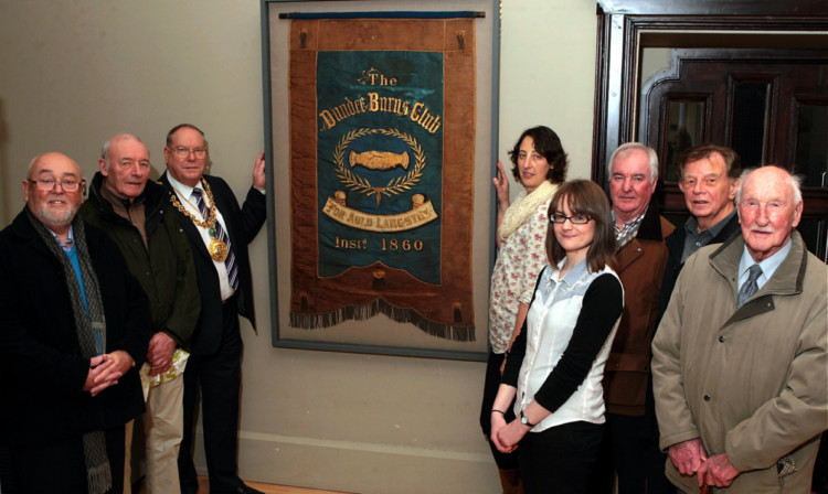 With the framed banner are, from left, Burns club members Bill Stewart and Jim Clarke, Lord Provost Bob Duncan, Rebecca Jackson-Hunt, Carly Cooper, of the museum, Burns club members Eddie Bonnar, George Fyffe and Tom Hay.
