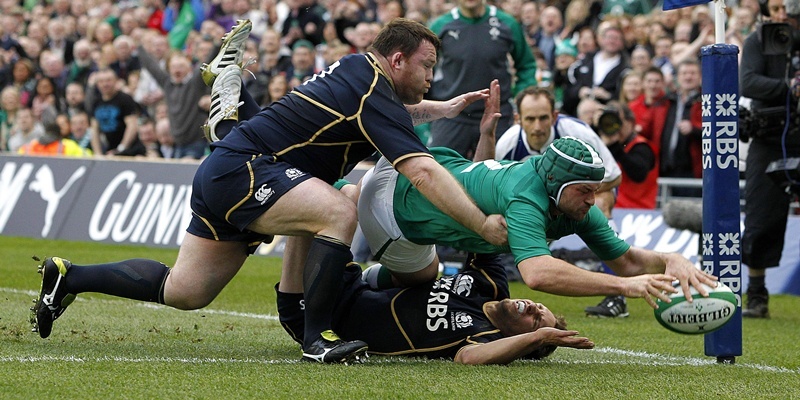 Ireland's Rory Best scoring a try despite Scotland's Mike Blair and Allan Jacobsen during the RBS 6 Nations match at the Aviva Stadium, Dublin, Ireland.