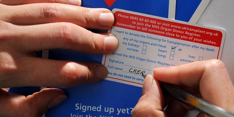 File photo dated 11/04/10 of a general view of a person signing up for an NHS Donor card.