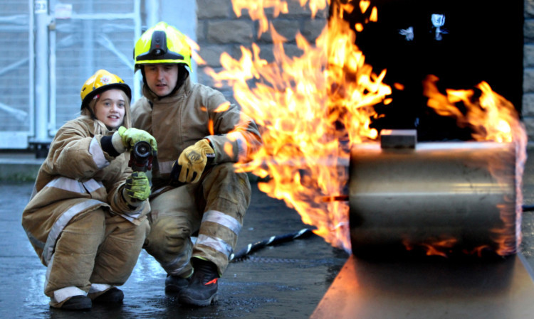 Melissa helping put out a fire during her tour of the fire station.