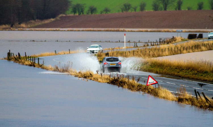 Drivers trying to find their way through deep flood water between Meigle and Alyth on Wednesday.