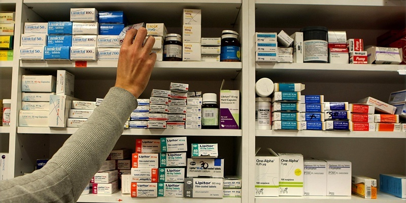 A pharmacist stocks shelves at a chemist in Dublin as Health Minister Mary Harney was urged to be cautious about adding a 50 cent fee on every drug prescribed to a medical card holder as part of a range of health service savings in the Budget.