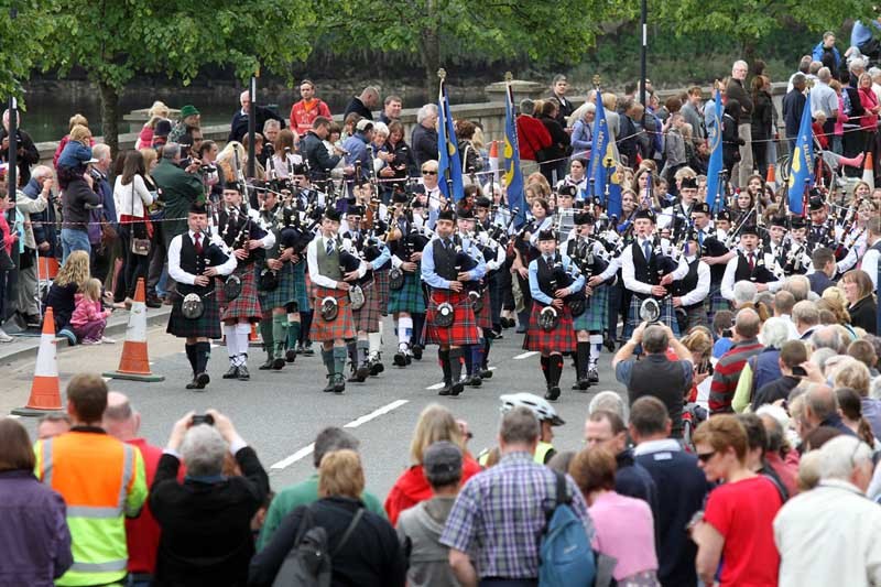 Steve MacDougall, Courier, Tay Street, Perth. Queen's Diamond Jubilee events in Perth; 1000 pipers parade. Pictured, the pipers parade along Tay Street surrounded by huge crowds.