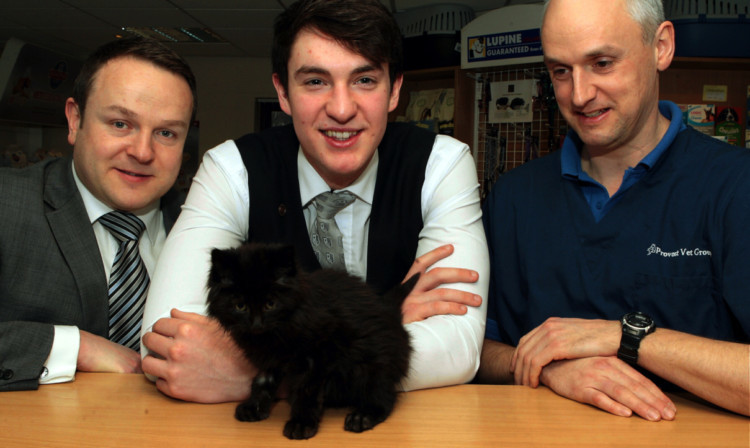 Jay Goldsmith, centre, will adopt the 12-week-old kitten if his owner cant be found, with Rusacks general manager Chris Feeney, left, and Will Goad, the director of Provost Vet Group.
