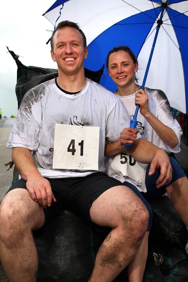 Kris Miller, Courier, 30/06/12. Picture today at Kelty Coal Race, Kelty. Almost 60 competitors, male and female took part in the gruelling challenge, running 1km with a 50kg bag of coal on their shoulders (25kg for ladies). Pic shows mens and ladies winners, Grant Cotter (Rosyth) and Hazel Porter (Dunfermline/Cowdenbeath).