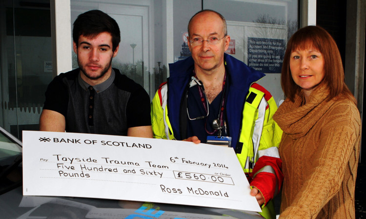 Ross and mum Morven present the cheque to A&E consultant Neil Nichol.