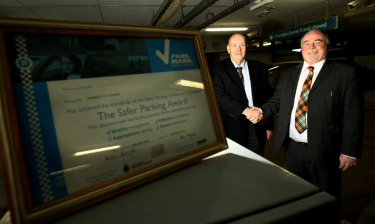 Steve Emmonds, team leader, parking, left, and Councillor Bill Campbell, depute convener city development, with the Park Mark award.