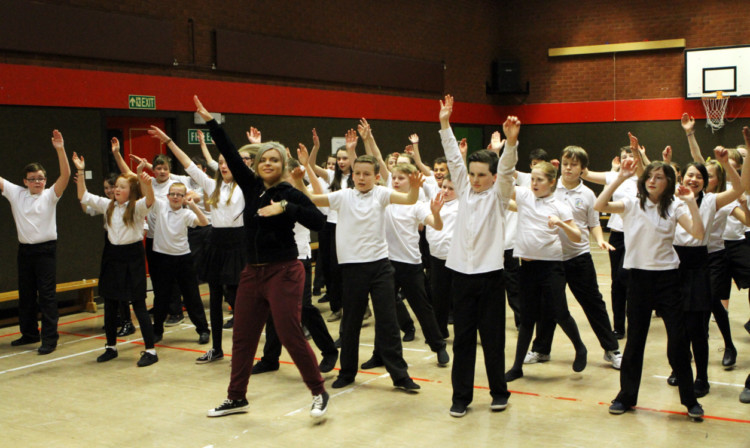 Primary seven pupils going through their  routine with dance teacher Kimberley Walker, ahead of the 'Rock Challenge'.