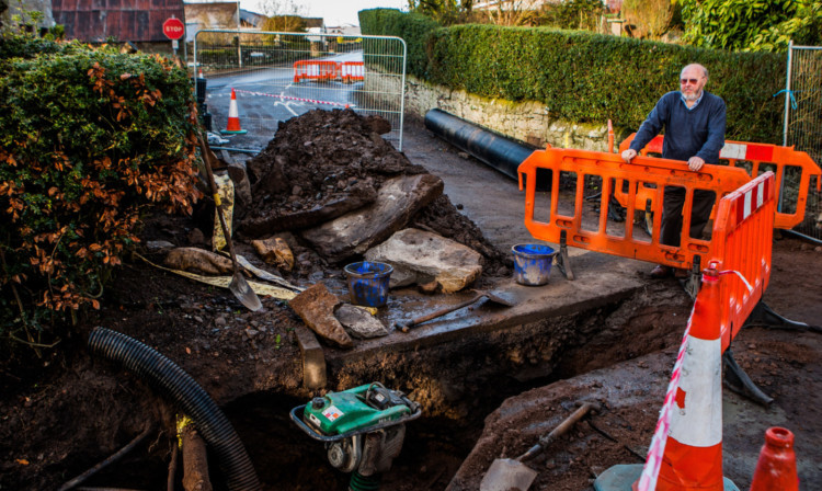 Ian Glen beside the emergency works taking place outside his 270-year-old cottage in Liff.