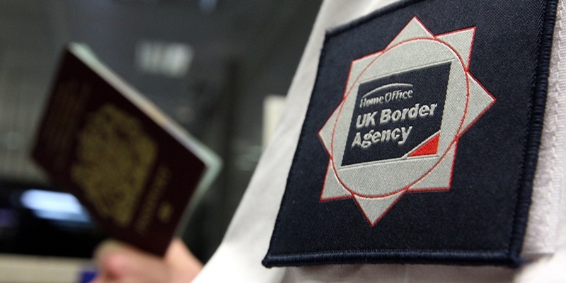 File photo dated 23/11/2009 of a UK Border Agency officer checking a passport in the North Terminal of Gatwick Airport, Sussex.