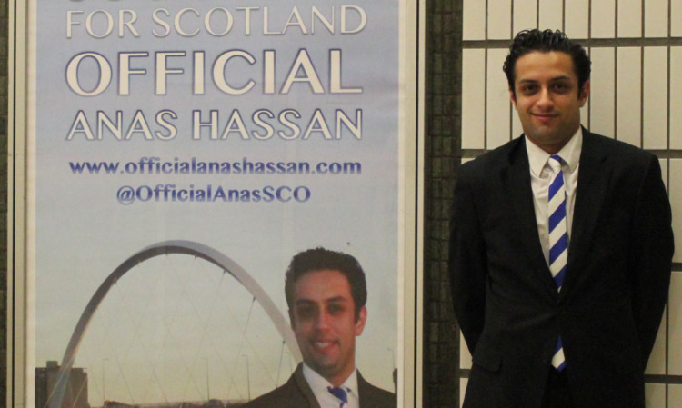 Anas Hassan at Glasgow Queen Street station with his advert.