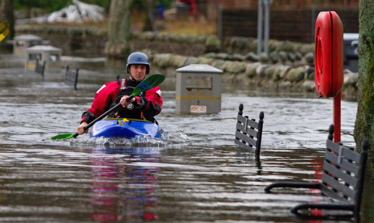 A canoeist negotiates floods in Callander. Flood protection for the town is a council priority.
