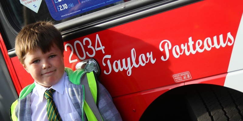 Kris Miller, Courier, 18/09/12. Picture today at National Express Depot, Dock St, Dundee where avid bus fan, Taylor Porteous had a bus named after him. The bus has his name painted on the front and side and Taylor also got to sit in the cab and control the number board. Pic shows Taylor with his name on 'his' bus.