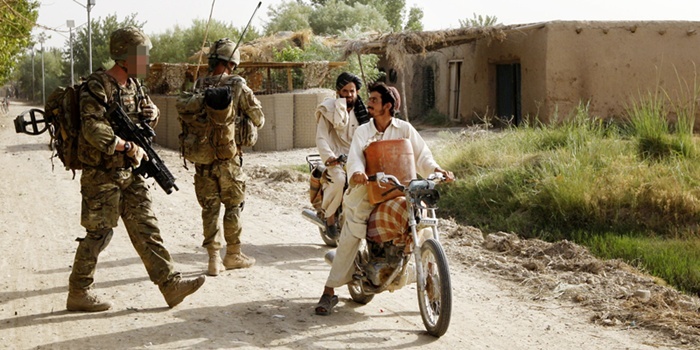 Marine Sam White (left) of X-Ray Company, 45 Commando Royal Marines, with locals in the village of Siadabad, while on patrol from Patrol Base Kalang in Afghanistan.