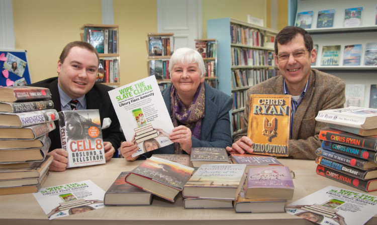 At Kirriemuir Library, from left: library assistant Geraint Rhys Davies, Angus Council vice-convener of communities Jeanette Gaul and Angus Foodbank manager Malcolm Brown.