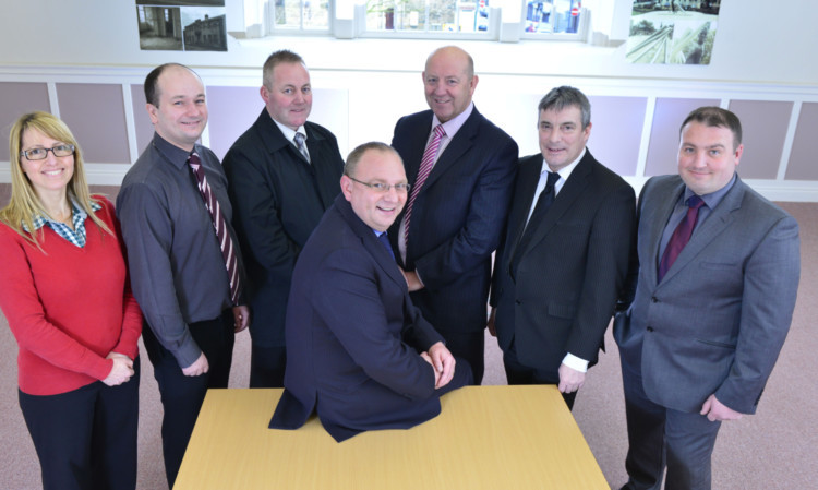Celebrating the move to a new headquarters: Martin Fernie, centre, with facilities administrator Hazel Beattie, projects co-ordinator Iain Arendt, head of safety and assurance John Richardson, commercial manager David Livingston, senior contracts manager Stuart Donald and electrical contracts manager Steve Rattigan.