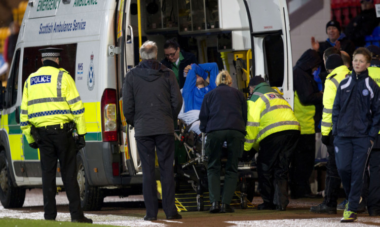 Murray Davidson is carted onto an ambulance after damaging his knee ligaments against Hearts.