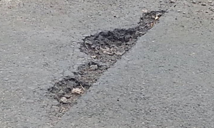 One of the many potholes that Councillor May says residents are complaining about.